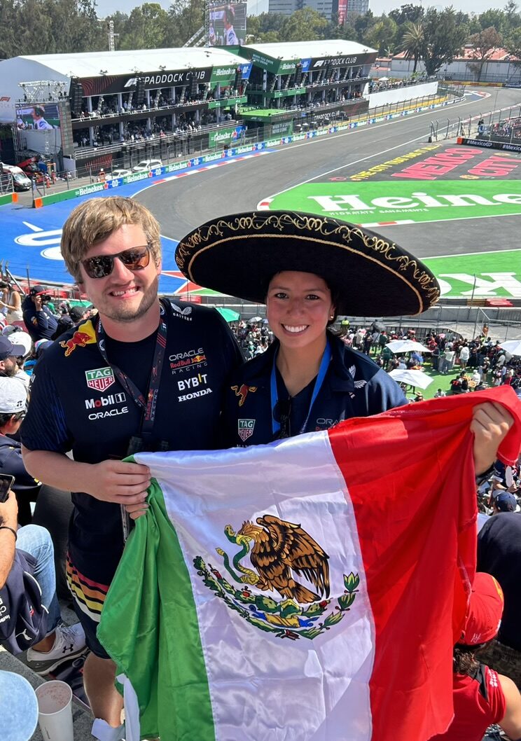 Paula and Felix at Formula 1 with a Mexican flag