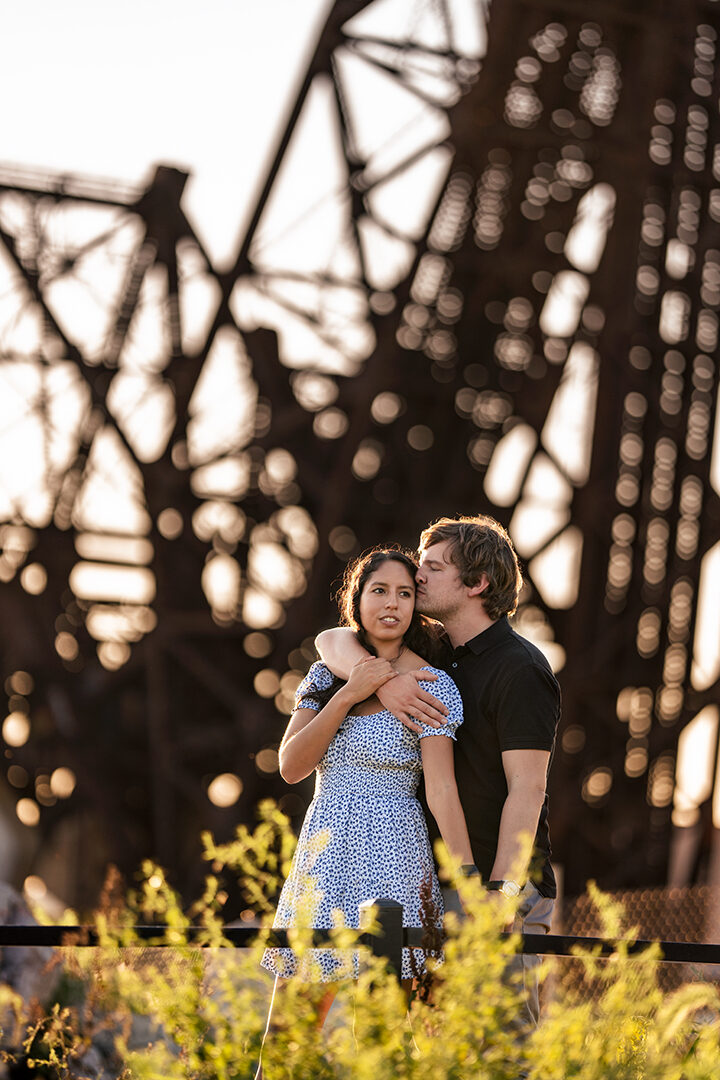 Paula and Felix under a bridge at sunset