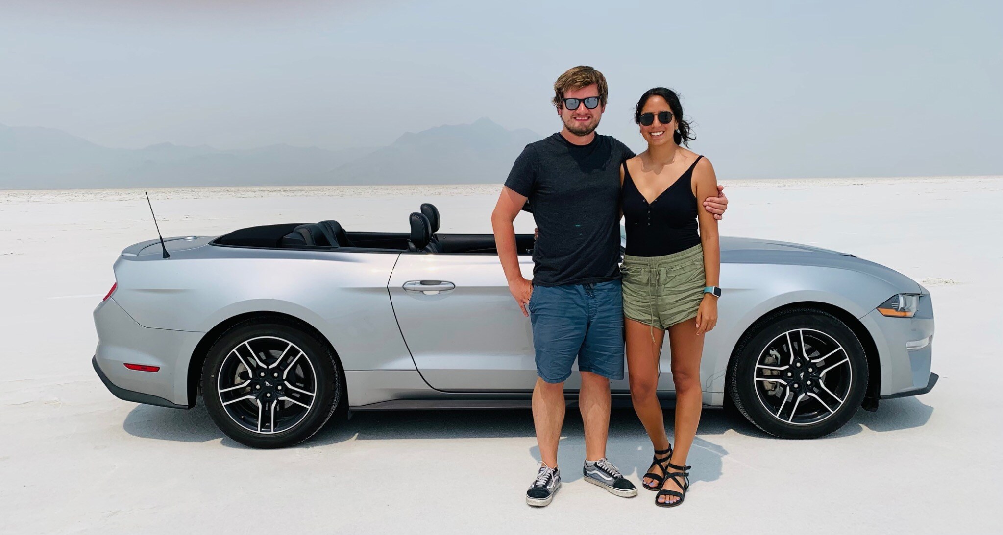 Paula and Felix beside a convertible at the Bonneville Salt Flats